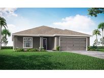 One-story home with gray exterior, two-car garage, and landscaped lawn at 1135 Aruba Ave, Mulberry, FL 33860