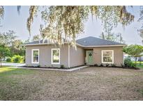 Charming single-story home with a well-maintained lawn and fresh landscaping at 1495 Davis Ave, Bartow, FL 33830