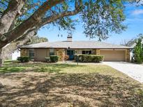 Single-story house with stone accents and a spacious driveway at 2004 Varner Cir, Winter Haven, FL 33884