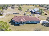 Aerial view of a ranch-style home with detached barn and expansive land at 2455 Gerber Dairy Rd, Winter Haven, FL 33880