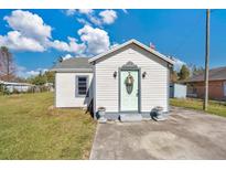 Charming single story home with a green door and well-maintained lawn at 2522 Burns St, Lakeland, FL 33801