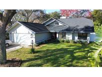 Single-Gathering home with a two-car garage and a well-manicured lawn at 4419 Burlington Dr, Winter Haven, FL 33880