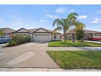 Two-story house with two-car garage and palm tree landscaping at 5771 Lacar Way, Lakeland, FL 33805