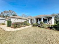 Inviting home exterior with landscaped yard and walkway at 6127 Magpie Dr, Lakeland, FL 33809