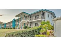 Two-story building with teal accents and screened balconies at 1600 W Lake Parker Dr # B9, Lakeland, FL 33805