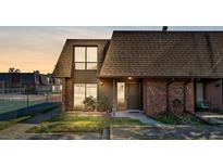 Inviting townhouse featuring a well-manicured lawn and a mix of brick and siding accents at 1836 N Crystal Lake Dr # 112, Lakeland, FL 33801