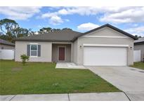 Charming single-story home with a well-maintained lawn and a two-car garage at 4932 St James St, Winter Haven, FL 33881
