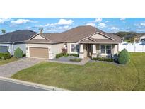 Charming single-story home with a well-manicured lawn, beautiful landscaping, and a two-car garage at 5012 Ridgefield Ln, Lakeland, FL 33812