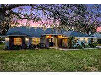 Beautiful one-story home with a landscaped lawn and brick accents at 7026 Parliament Pl, Lakeland, FL 33809