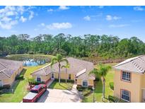 Inviting home with a tiled roof, lush landscaping, and a peaceful pond in the backyard at 116 Ocean Bluff Dr # 116, Kissimmee, FL 34759