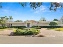 Stunning home with a lush front yard, beautiful landscaping, and a circular brick driveway at 1401 Easton Dr, Lakeland, FL 33803