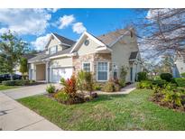 Charming home featuring stone accents, manicured lawn, and an attached two-car garage at 2038 Winterset Dr # 2038, Lakeland, FL 33813