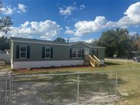 Charming single-story home featuring a well-manicured lawn and a classic exterior design at 2403 Gerties Rd, Bartow, FL 33830