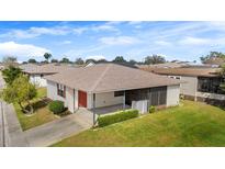 Charming single-story home featuring a screen enclosed patio, landscaped yard, and a well-maintained lawn at 3203 Bear Creek Ln, Lakeland, FL 33810