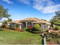 Charming single-story home with lush landscaping, a well-manicured lawn, and an inviting entrance at 324 Lake Mariam Blvd, Winter Haven, FL 33884