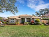 Landscaped front yard featuring a charming home with a well-manicured lawn and lush plantings at 324 Lake Mariam Blvd, Winter Haven, FL 33884