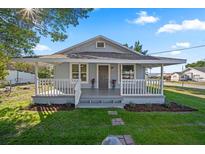 Charming home with a large front porch, fresh landscaping and a welcoming walkway at 602 E Orange St, Auburndale, FL 33823