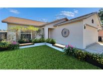 Charming home with well-maintained landscaping and flower beds at 6610 Shepherd Oaks St, Lakeland, FL 33811