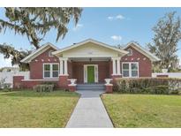 Charming brick home with a welcoming green door and well-maintained front lawn at 1539 E Fern Rd, Lakeland, FL 33801