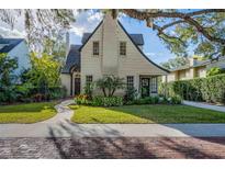 Charming home featuring a well-manicured lawn, lush landscaping, and a stone walkway leading to the entrance at 1819 Pawnee Trl, Lakeland, FL 33803