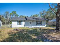 Charming single-story home with a brick exterior, well-maintained lawn, and complementary blue shutters at 2926 Delrose N Dr, Lakeland, FL 33805