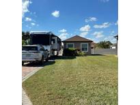 Charming single-story home featuring a well-maintained lawn and space for RV parking at 441 Nolane Ln, Polk City, FL 33868