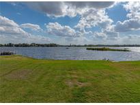 Expansive backyard with lush green grass leading to the waterfront at 5418 Cooper Ln, Fort Meade, FL 33841