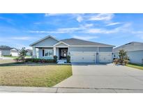 Charming single-story home with well-manicured lawn and a three-car garage, located in a Gathering-friendly neighborhood at 5806 Valentino Way, Lakeland, FL 33812