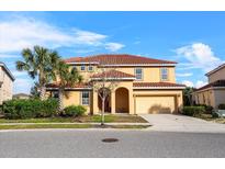 Two-story house featuring a clay tile roof, front lawn, and a two car garage at 6160 Broad Oak Dr, Davenport, FL 33837