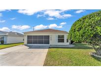 Charming single-story home featuring a well-maintained lawn, attached garage, and inviting curb appeal at 6193 Magpie Dr, Lakeland, FL 33809