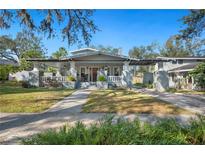 Charming craftsman home with a large front porch, brick pillars, and mature landscaping at 815 Success Ave, Lakeland, FL 33801