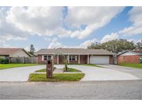 Charming brick home with a well-maintained front yard, and a circular driveway at 144 Mirror Nw Ln, Winter Haven, FL 33881