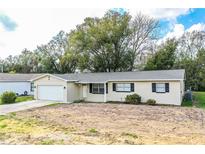 Charming single-story home with a well-manicured lawn and attached two-car garage at 1548 Churchill Ct, Lakeland, FL 33801