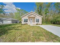 Charming single-story home with a well-manicured lawn and a modern design at 2161 Maple Hill Ct, Lakeland, FL 33811