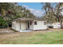 Cozy single-story home featuring a covered front porch and a well-maintained lawn at 2638 Ralph Rd, Lakeland, FL 33801