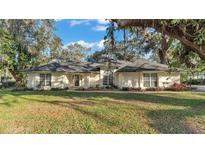 Charming one-story home with well-maintained lawn, mature landscaping and a cozy front porch at 3328 Imperial Ln, Lakeland, FL 33812