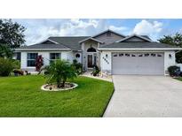 Charming single-story home featuring a well-manicured lawn and a welcoming two-car garage at 5982 Crane Dr, Lakeland, FL 33809