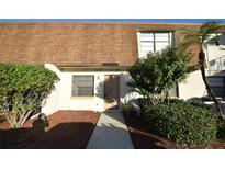 Inviting condo featuring a well maintained exterior with mulch landscaping and mature shrubbery at 6055 Topher Trl # 6055, Mulberry, FL 33860