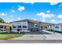 Charming single-story home with a covered carport, welcoming front patio, and landscaped front yard at 6792 Brentwood Ne Dr, Winter Haven, FL 33881