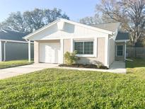 Charming single Gathering home with a one car garage, landscaped yard, and a welcoming front entrance at 1317 Bramblewood Dr, Lakeland, FL 33811