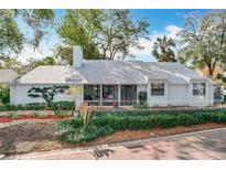 Charming single-story home with a manicured lawn, white picket fence, and inviting front porch at 21 Townhill Dr, Eustis, FL 32726
