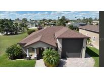 Charming single-story home with well-manicured lawn, mature palms, and a two-car garage at 246 Laynewade Rd, Polk City, FL 33868