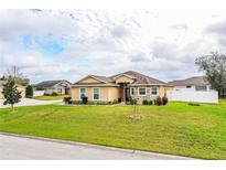 Charming one-story home featuring a well-manicured lawn and tasteful landscaping at 3510 Kenwood Xing, Lakeland, FL 33812
