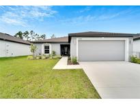 Charming single-story home with well-manicured lawn and a two-car garage at 6296 Dolostone Dr, Lakeland, FL 33811