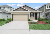 Charming single Gathering home boasting a well-manicured lawn and a two-car garage at 6533 Great Bear Dr, Lakeland, FL 33805