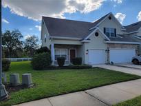 Charming townhouse with a well-manicured lawn and attached one car garage at 2051 Winterset Dr, Lakeland, FL 33813