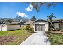 Inviting single-story home featuring a clean driveway, attached garage, and tidy front yard at 29 Buck Cir, Haines City, FL 33844