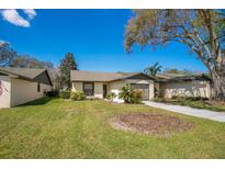 Charming home featuring a well-manicured lawn and mature landscaping in a tranquil neighborhood at 29 Buck Cir, Haines City, FL 33844