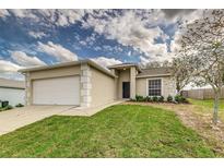 Charming single-story home featuring a well-manicured lawn and a two-car garage at 3815 Horizon View Loop, Lakeland, FL 33813