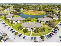 Stunning aerial view of condo community with lush landscaping and serene pond at 507 Eagle Pond Dr # 507, Winter Haven, FL 33884